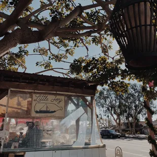 a small food stand under a tree