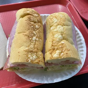 two sandwiches on a paper plate