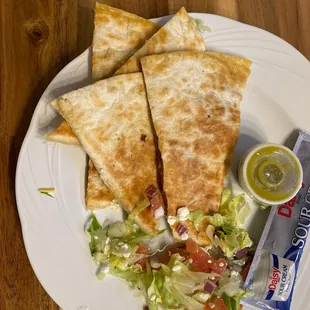 a plate of quesadillas and salad