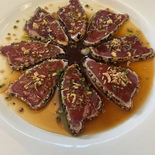 a plate of sliced tuna