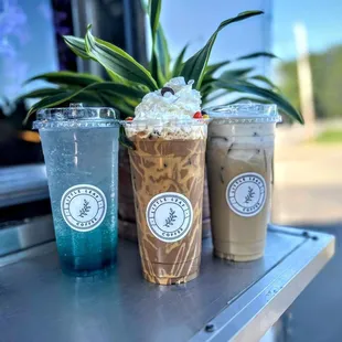 three cold drinks on a table