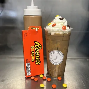 a cup of milkshake and a container of candy