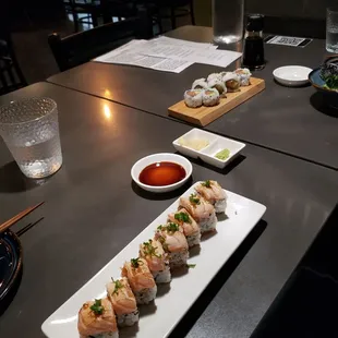 Foreground: 2022 roll, w/lightly seared salmon and a garlic salmon inside. Back: Alaska Roll.