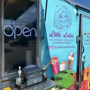 a food truck with an open sign