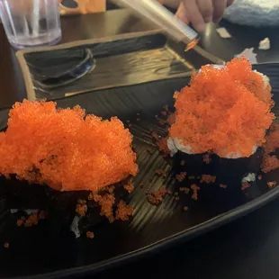 To 2 Pieces Tobiko Nigiri and tobiko on cucumber roll. Note - we asked for extra tobiko.