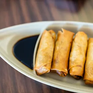 a plate of fried spring rolls