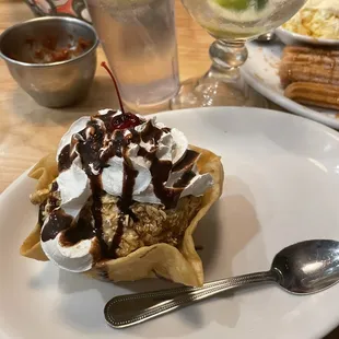 a banana split with whipped cream and chocolate sauce
