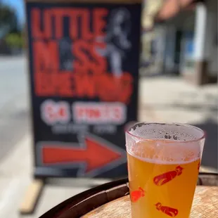 a glass of beer on a barrel