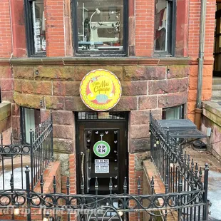 a parking meter in front of a brick building
