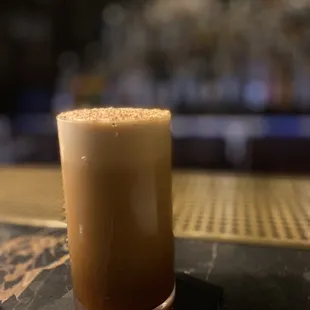 a drink in a tall glass on a coaster