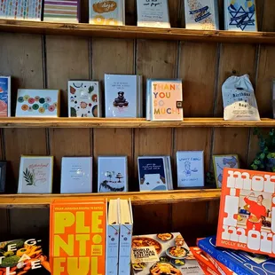 a display of books on a wooden shelf
