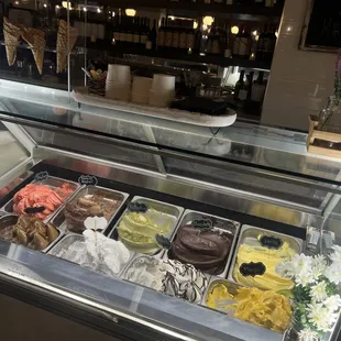 Gelato selection on a Saturday I visited. Waffle cones looked sad because waffle cones don&apos;t do well in humidity. Got a cup instead.