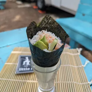 a sushi roll with avocado and cucumber