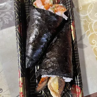 The salmon Toro hand roll (left) and BBQ eel hand roll (right)