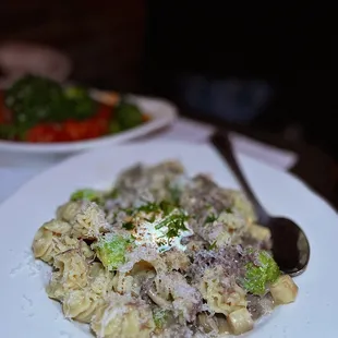 a plate of pasta with meat and vegetables