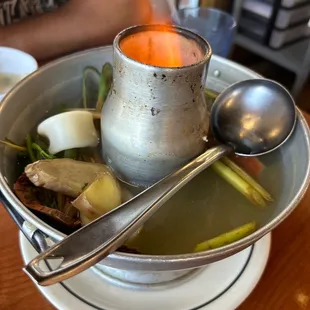 a bowl of soup with spoons