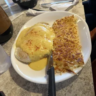 Eggs Benedict and hash browns.