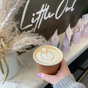 a person holding a cup of coffee