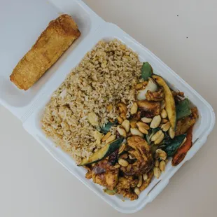 a take out container with rice and vegetables