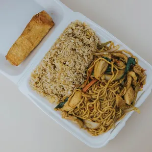 a take out container with noodles and tofu