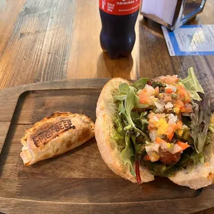 Spicy beef empanada and a choripan with a coke and my smile.