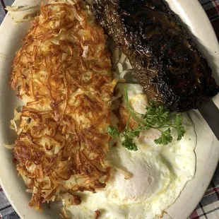 Breakfast with a smile (teriyaki steak) eggs, hash browns and toast.