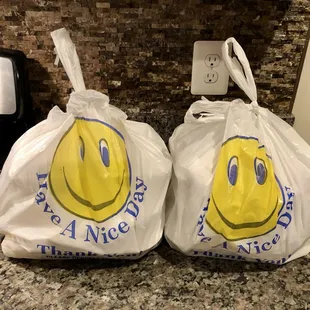 two bags with smiley faces