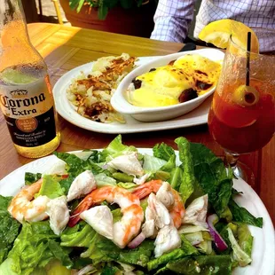 Sunday brunch. Mediterranean salad with lump crab + shrimp &amp; eggs Benedict enjoyed al fresco.