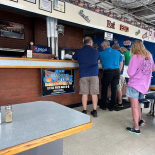 people standing in line at the counter