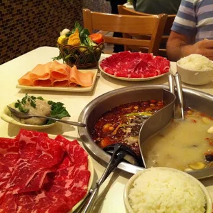 Two meats, chicken, veggies, fish paste. Broth: herbal on right and mala on left (very spicy).