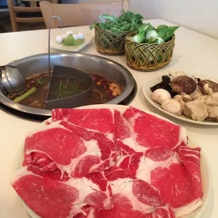 Prime rib with mushroom platter, quail eggs, watercress, and baby bok choy with mala broth