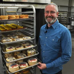 a man holding a tray of cookies