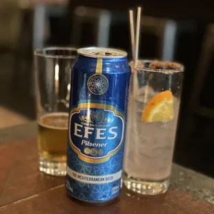 a can of beer and a glass of water