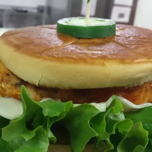 a sandwich with a pickle on top