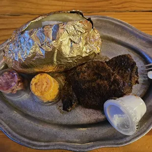6 ounce sirloin medium well with a loaded baked potato