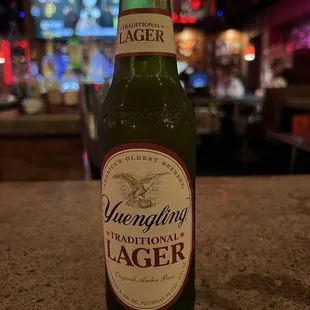 a bottle of beer sitting on a counter