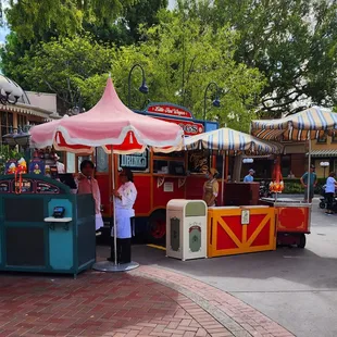 a food stand with a red and yellow tent