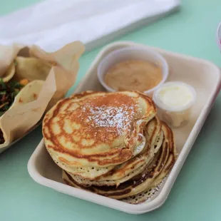 a plate of pancakes and a drink