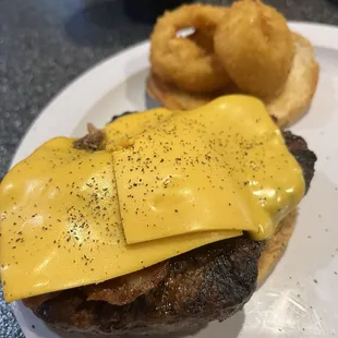 Sad bbq burger with sauce on side.