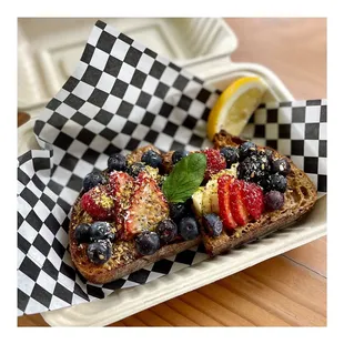 a slice of toast with berries and blueberries