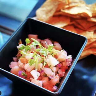 a bowl of salsa and chips