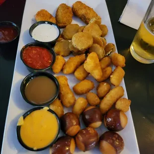 Sampler with Poppers, Fried Pickle Chips, Cheese Curds, and Buckeye Bites, Ranch, Marinara, Caramel sauce, Beer Cheese.