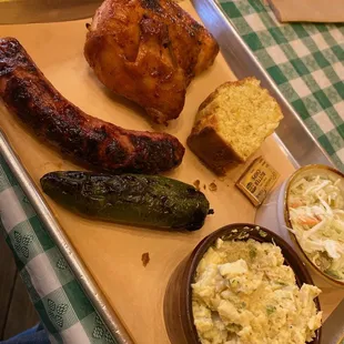 BBQ chicken, brat, potato salad, coleslaw, cornbread