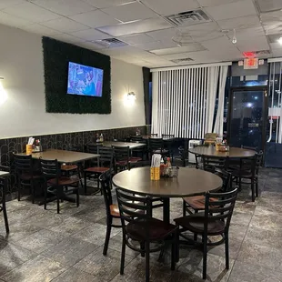 tables and chairs and a flat screen tv