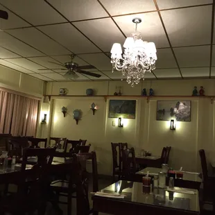 a restaurant with a chandelier hanging from the ceiling