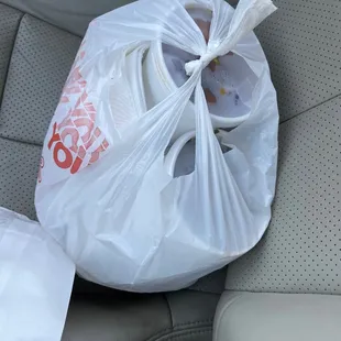 a bag of food in the back seat of a car