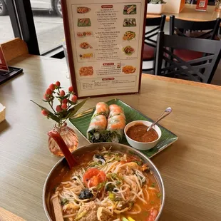 Crab noodle soup with tomatoes, tofu! Large purple mint leaves, bean sprouts , onions, garlic, chili peppers, lime !  Shrimp spring rolls