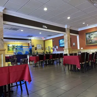tables and chairs with red tablecloths