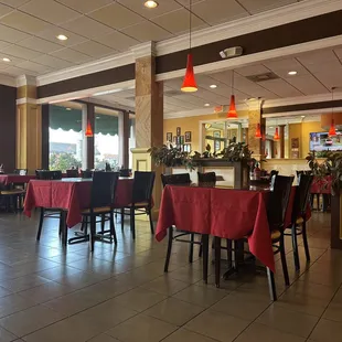 tables and chairs with red tablecloths