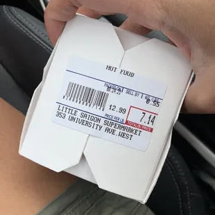 a person holding a box of food